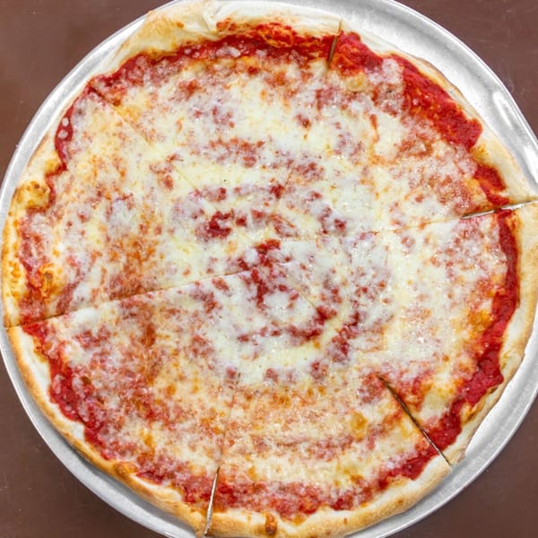 A classic Carini's cheese pizza, cut into slices, on a metal pizza pan.